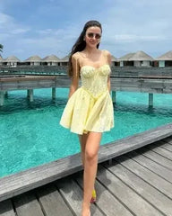 YENKYE Sexy Elegant Women Hollow Out Embroidery Yellow Sling Mini Dress Low Waist Lace Up Bandage Party Dresses Birthday Robe